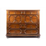 A William and Mary oak chest of small proportions, the four variously sized drawers with moulded