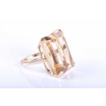 A 9ct yellow gold and citrine cocktail ring, set with a large mixed rectangular-cut citrine of