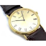 An 18ct yellow gold Paul Buhre mechanical wristwatch, the gilt dial with black Roman numerals, on