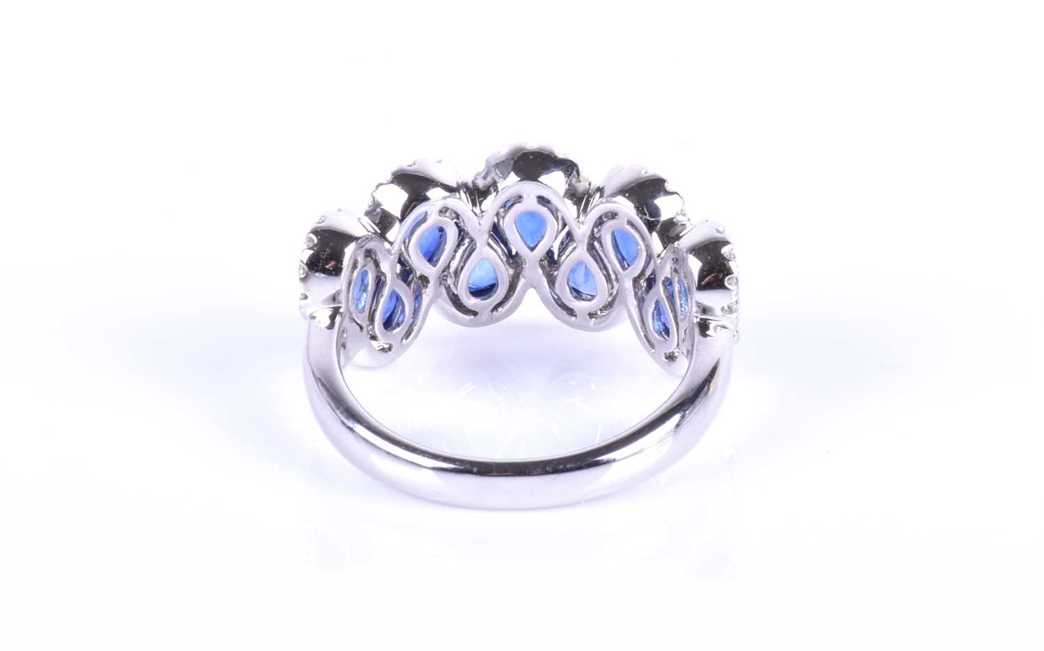An 18ct white gold, diamond and sapphire ring, the rounded mount set with a row of mixed pear-cut - Image 3 of 8