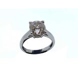 A platinum and solitaire diamond ring, set with a cushion-cut cognac diamond of approximately 3.90