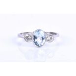 A platinum, diamond and aquamarine ring, set with a mixed oval-cut aquamarine of approximately 1.