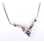 A yellow metal, diamond and sapphire spray pendant necklace, set with marquise-cut sapphires and
