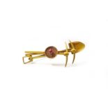A late Victorian 15ct yellow gold 'gold digger' brooch, set with a round-cut ruby, South African