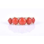 A Continental yellow gold, coral and diamond ring, set with five graduated round cabochon coral,