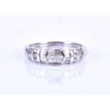 An unusual 14kt white gold and diamond ring, centred with a squared mount formed of three square-cut