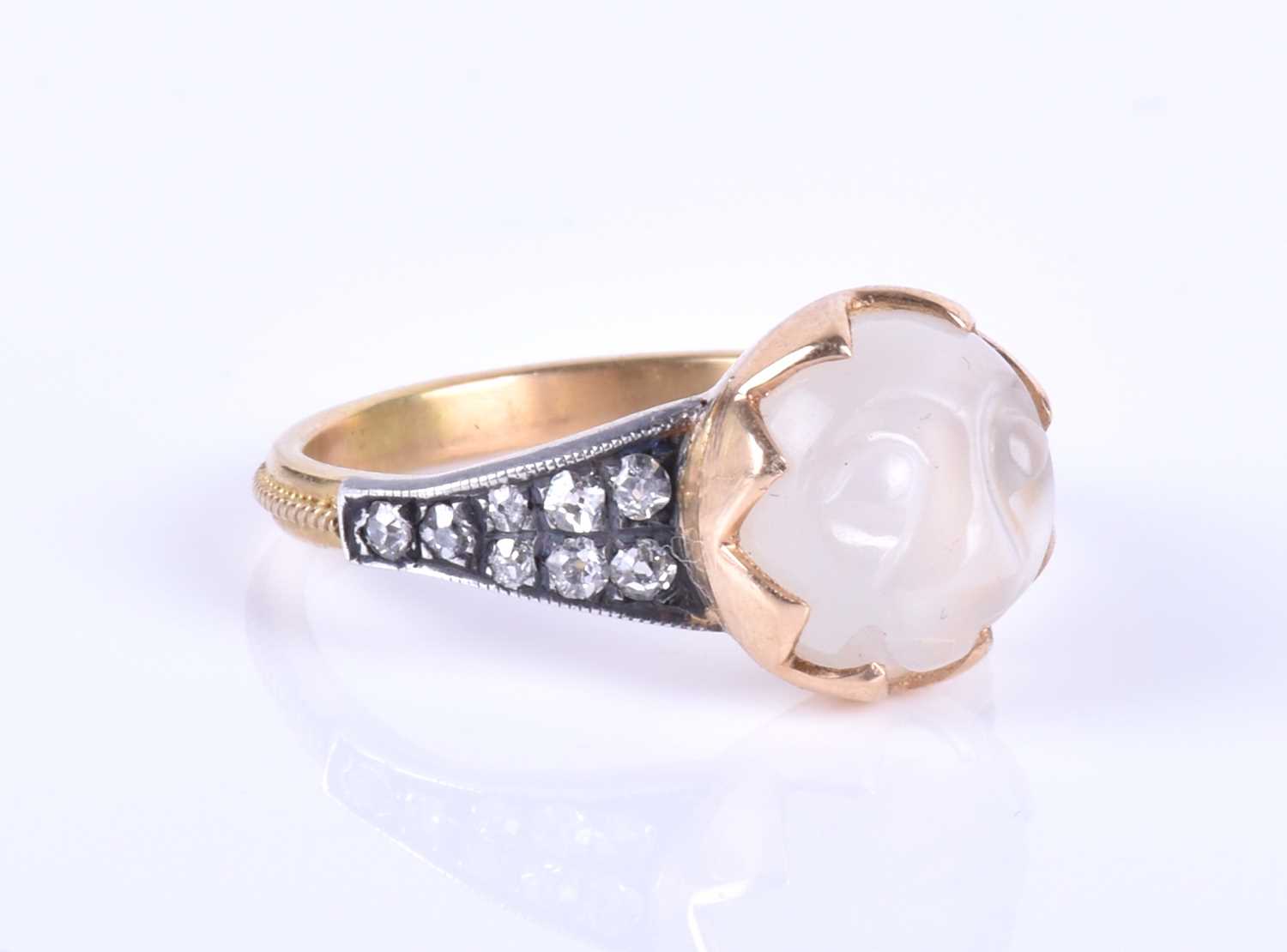 An unusual carved moonstone ring, centred with a moonstone carved in the form of a face, the tapered - Image 2 of 7