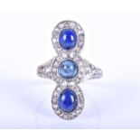 An Art Deco style diamond and sapphire ring, the triple clusters set north to south with three