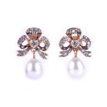 A pair of diamond and pearl drop earrings, the silver set gold-backed bow-shaped mounts inset with