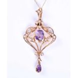 An Edwardian yellow metal, pearl and amethyst pendant, of openwork form, set with split seed