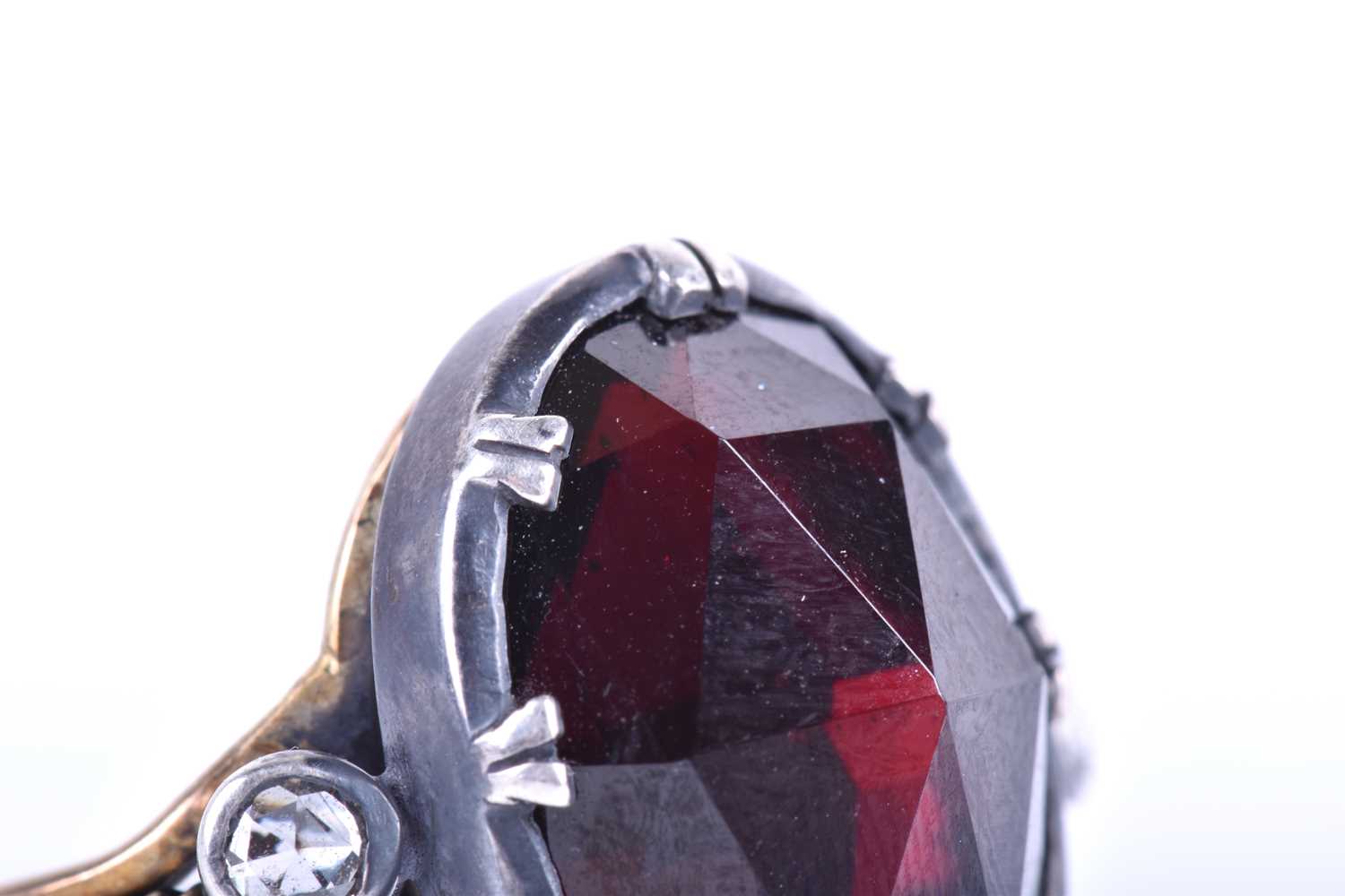 A silver, gold and garnet cocktail ring, set with a large oval rose-cut garnet, set in silver, - Image 2 of 10