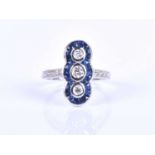 An 18ct white gold, diamond and sapphire ring, in the Art Deco style, the north to south mount inset