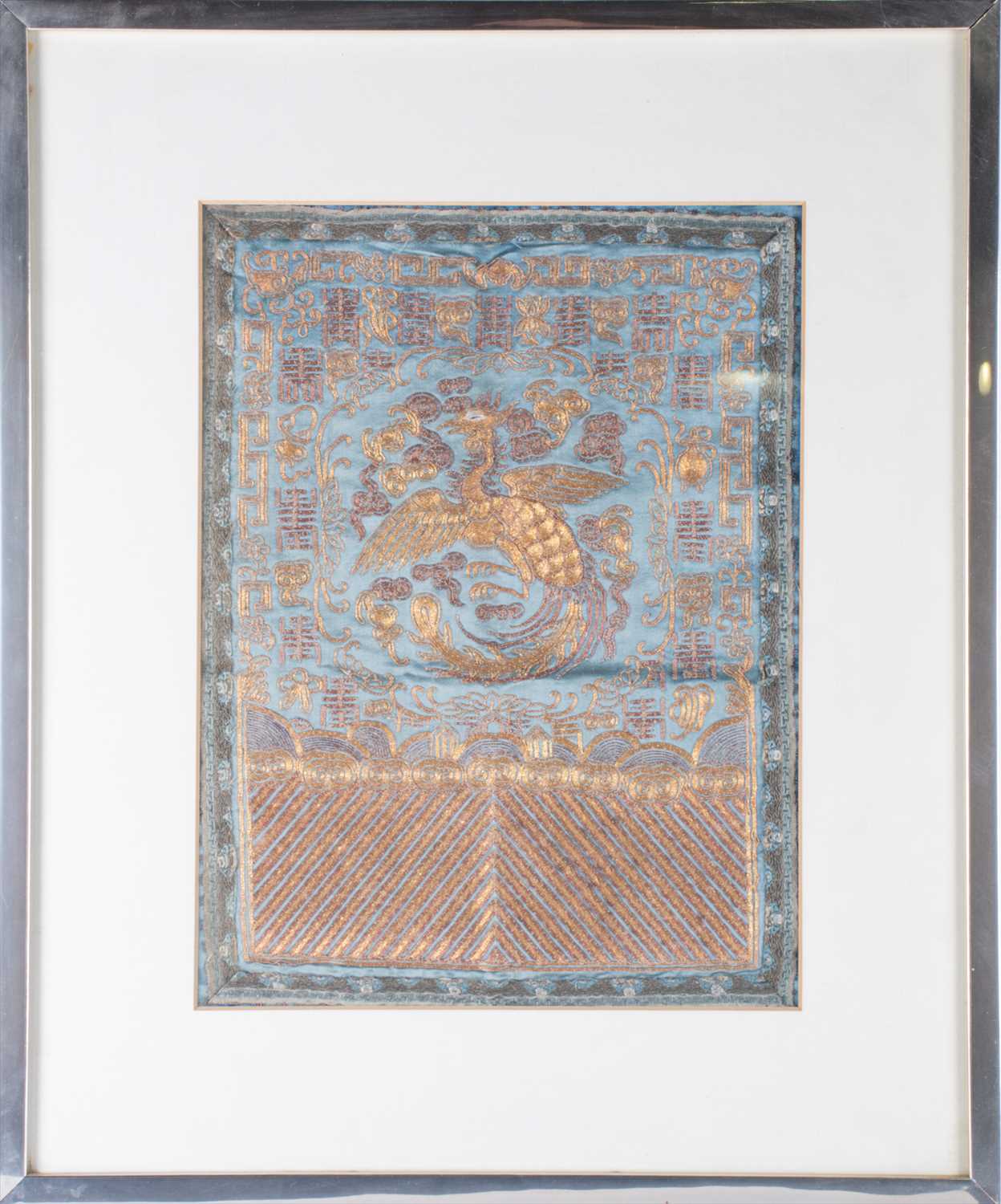 A framed 19th century Chinese silk panel with gilt braid, depicting a phoenix amongst geometric