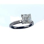 An 18ct white gold diamond ring, the central GIA certificated Asher cut diamond of K colour and VVS1