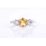 A diamond and yellow sapphire ring, centred with an asscher-cut yellow sapphire of approximately 1.