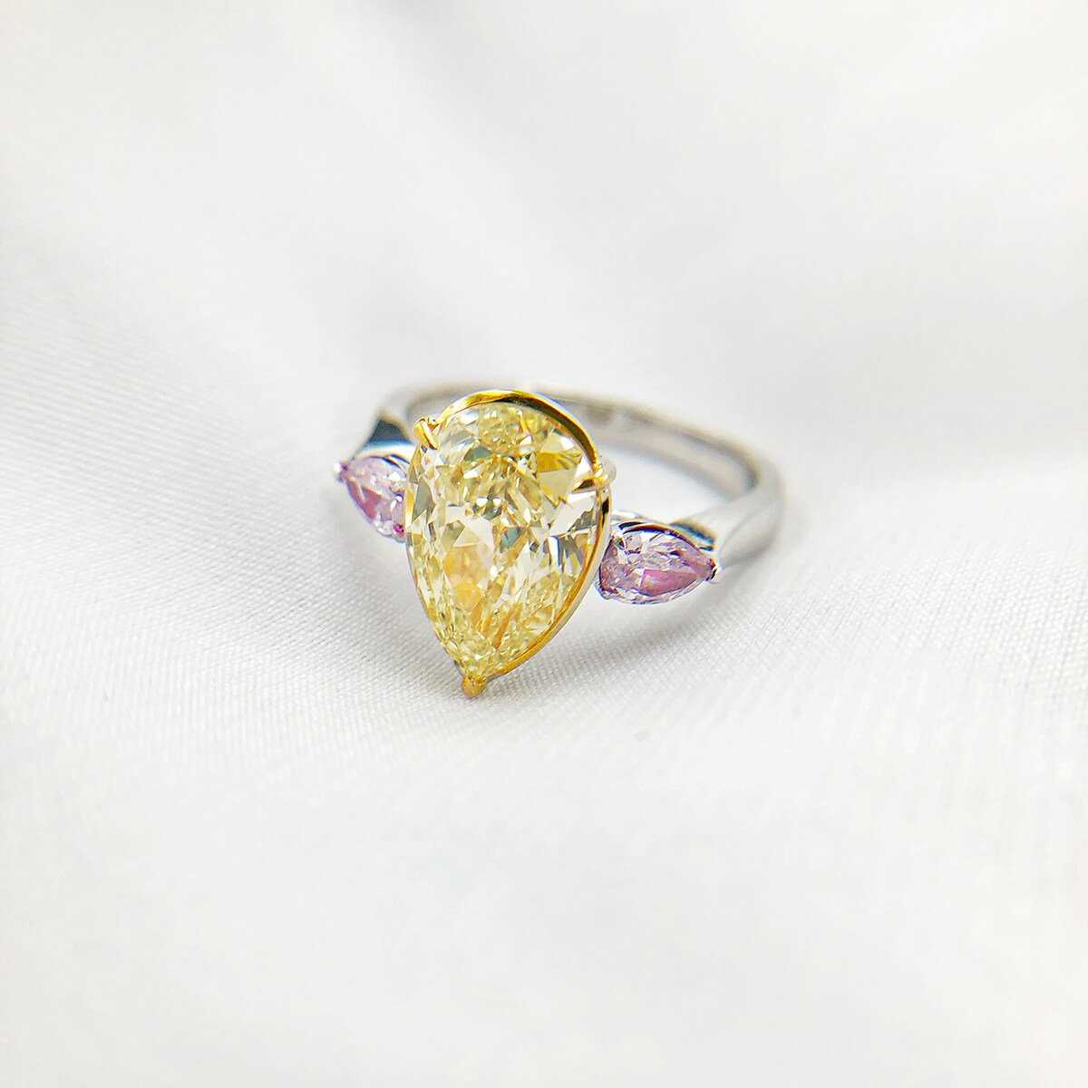 An impressive 18ct gold and fancy-yellow diamond ring, centred with a pear-cut fancy yellow - Image 2 of 5