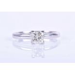 A 14k solitaire diamond ring, set with a mixed square-cut diamond of approximately 0.40 carats,