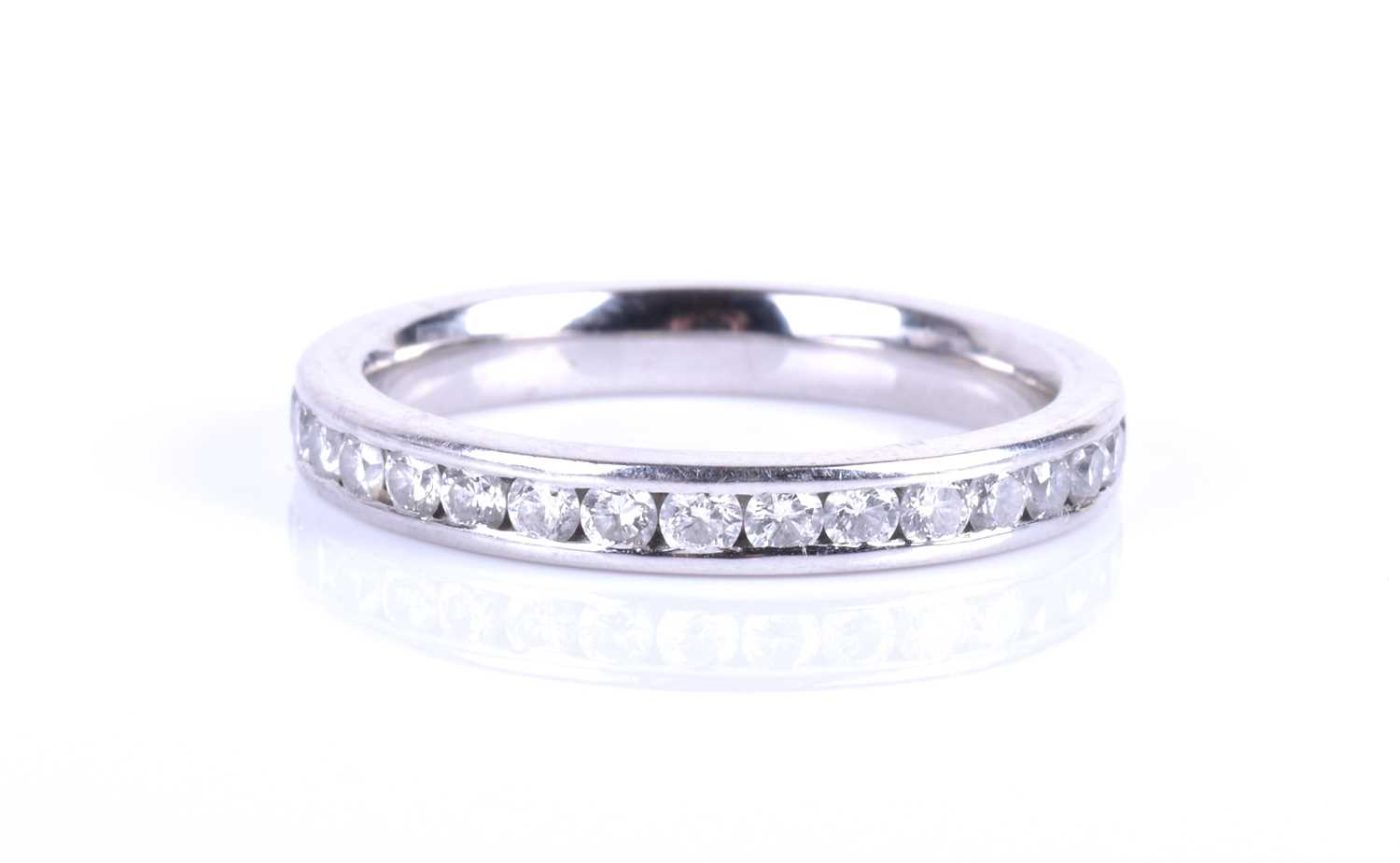 A platinum and diamond eternity ring, channel-set with round brilliant-cut diamonds of approximately