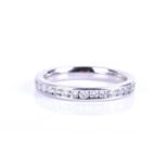 A platinum and diamond eternity ring, channel-set with round brilliant-cut diamonds of approximately