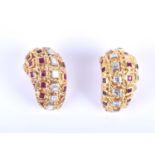 An unusual pair of diamond and ruby ear clips, of tapered rounded form, the yellow metal mounts with