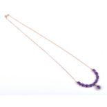 A 14ct yellow gold, amethyst and CZ necklace, set with an articulated line of mixed oval-cut