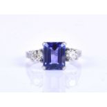A diamond and tanzanite ring, set with an emerald-cut tanzanite of approximately 3.40 carats,