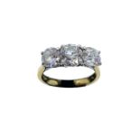 An 18ct yellow gold three stone diamond ring, the central old brilliant cut diamond of J colour