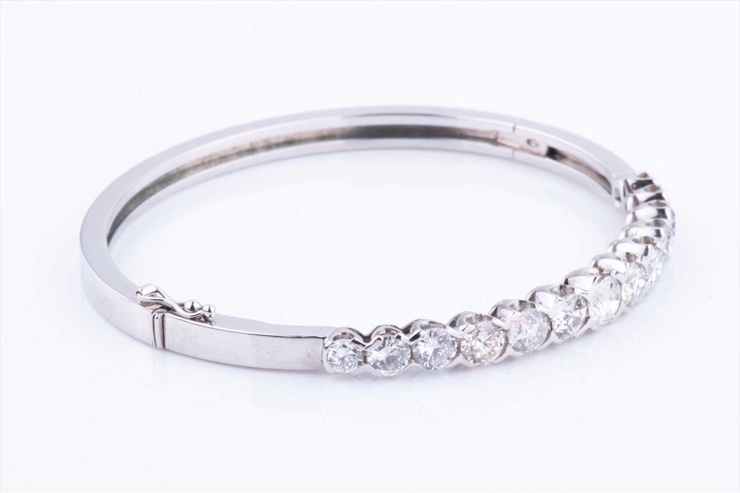 An 18ct white gold and diamond hinged bangle, set with thirteen round brilliant-cut graduated - Image 4 of 6