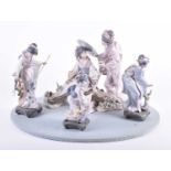 A large Lladro group of Japanese geisha figures, comprising two ladies upon a bridge, together