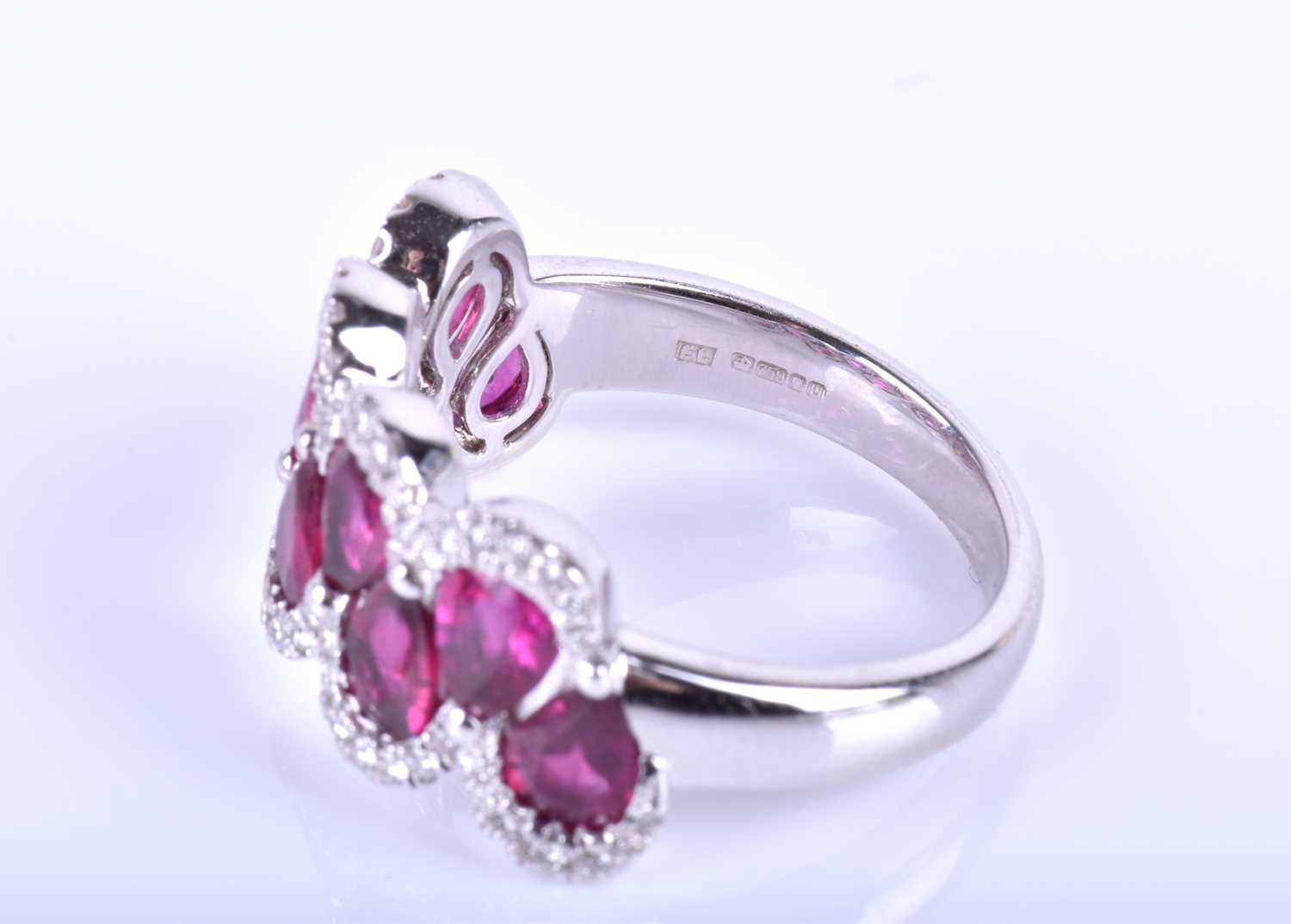 An 18ct white gold, diamond and ruby ring, the rounded mount set with a row of mixed pear-cut rubies - Image 3 of 6