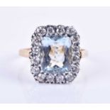 A diamond and aquamarine cluster ring, centred with a mixed rectangular-cut aquamarine of