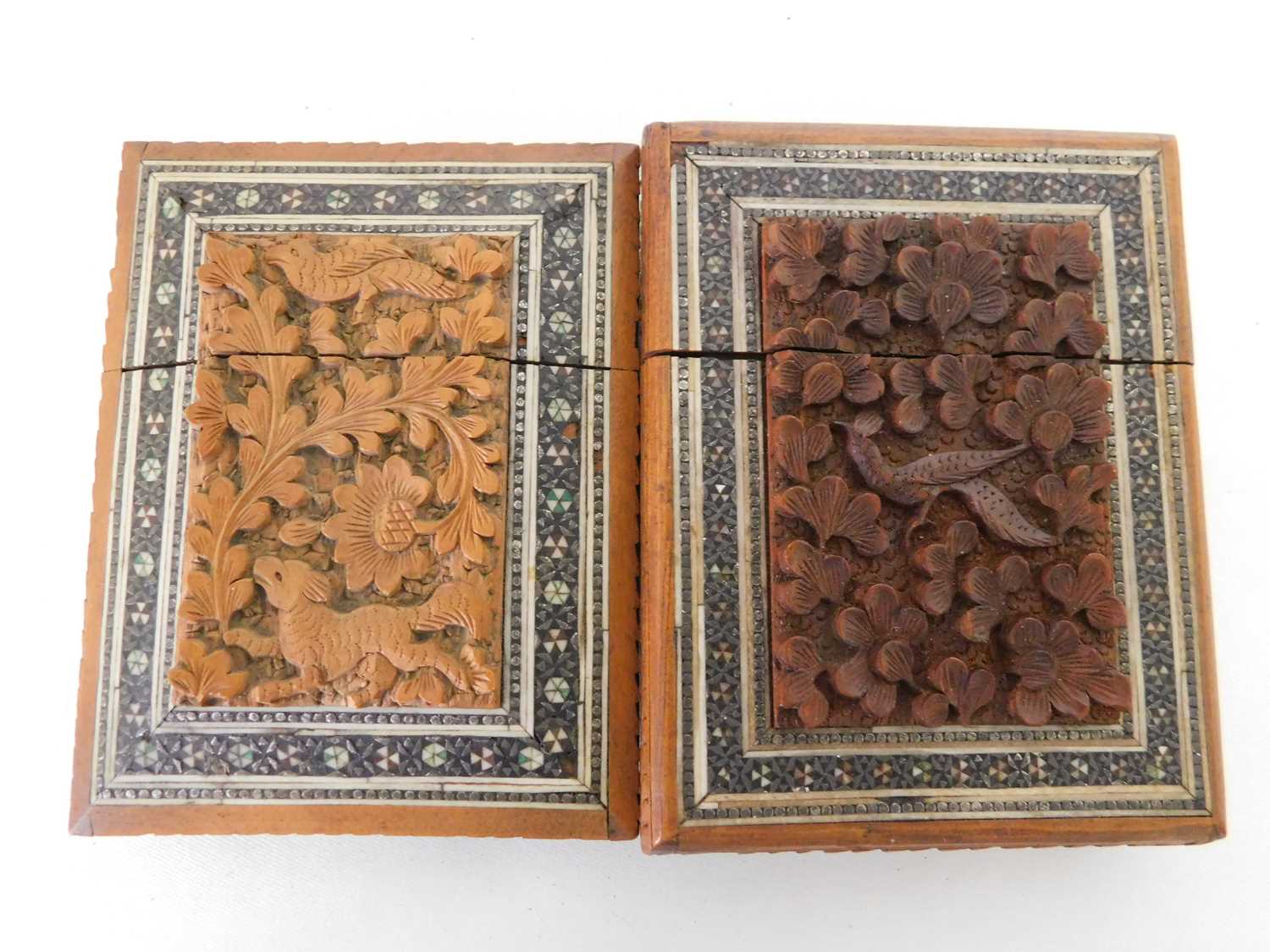 Two 19th century Indian carved sandal wood and sadeli card cases, each central panel carved in