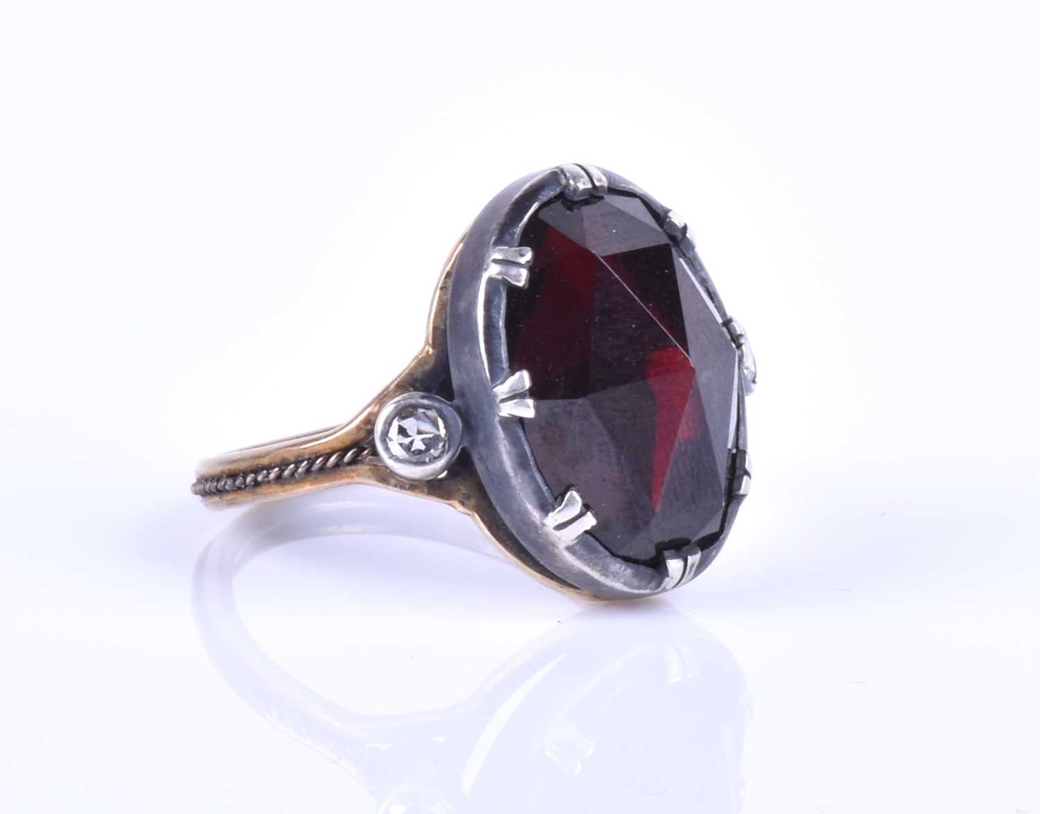 A silver, gold and garnet cocktail ring, set with a large oval rose-cut garnet, set in silver, - Image 10 of 10