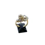 An 18ct yellow gold, pearl and diamond ring, set with four brilliant cut diamonds of H colour and