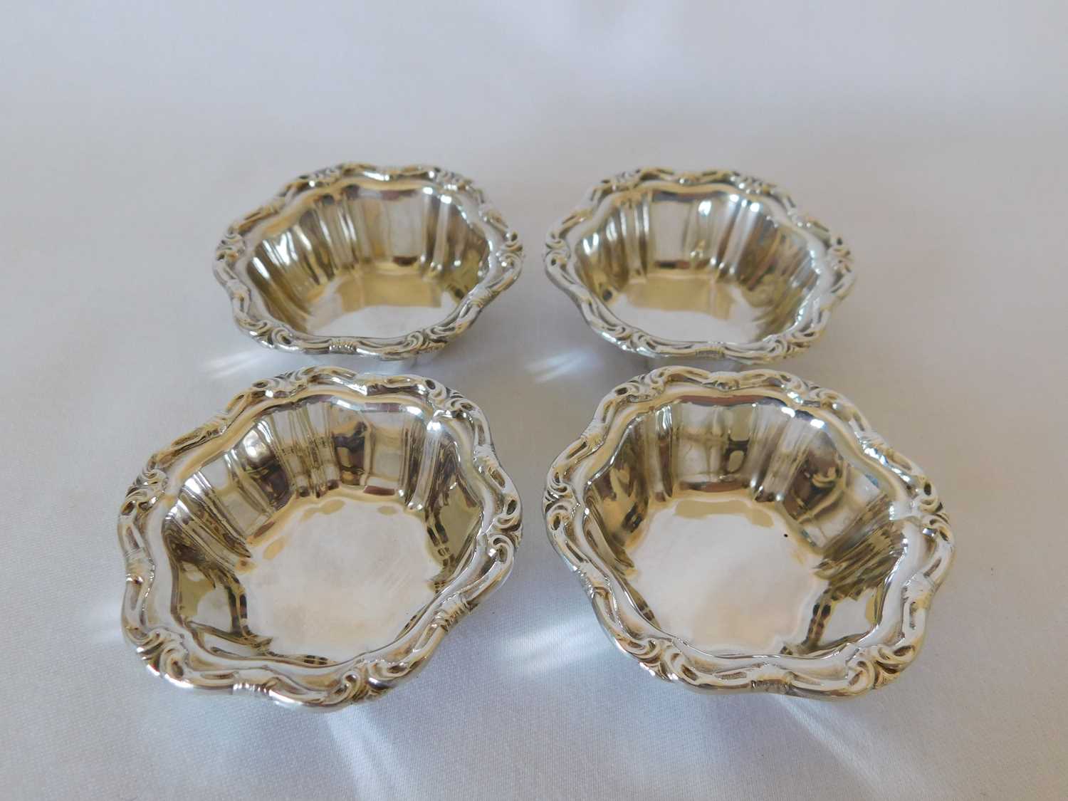 A set of four Canadian silver nut dishes, early 20th century, each with scroll decorated rim, struck