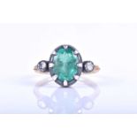 An unusual emerald and diamond ring, set with a mixed oval-cut emerald, eight-claw set in silver,