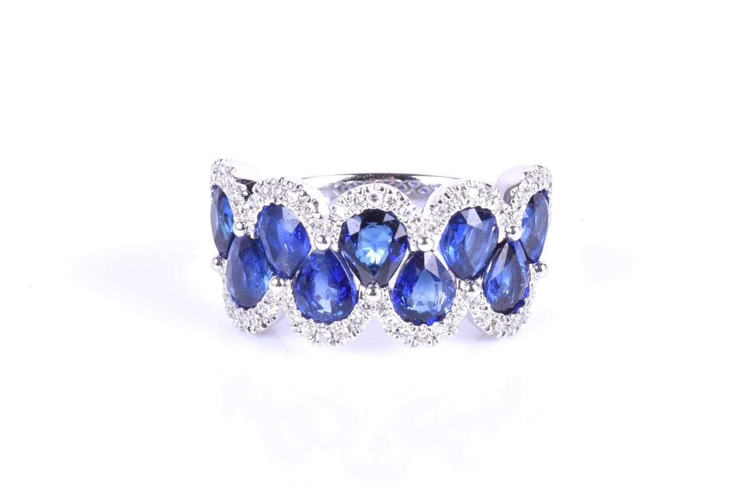 An 18ct white gold, diamond and sapphire ring, the rounded mount set with a row of mixed pear-cut - Image 6 of 8
