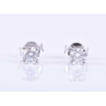 A pair of solitaire diamond ear studs, set with round brilliant-cut diamonds of approximately 0.80