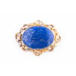 A Victorian yellow metal and lapis lazuli mourning brooch, set with a large oval lapis plaque,