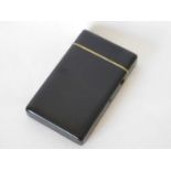 A black lacquer card case, late Victorian, with brass release button and ivory slip mounts.8.5cm x
