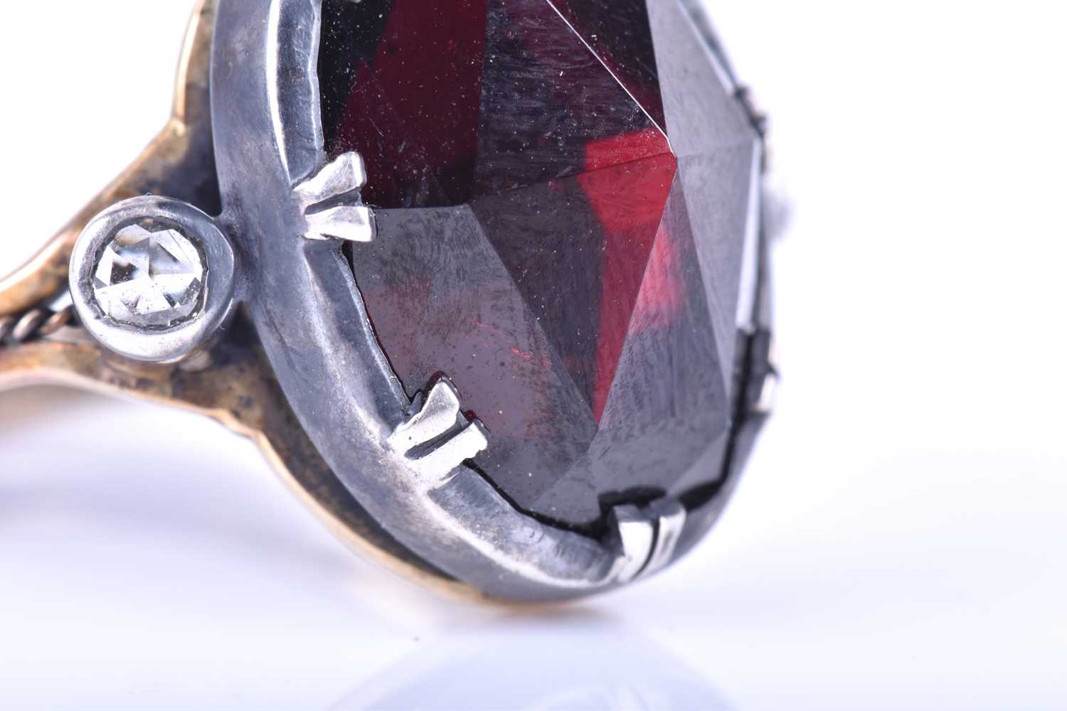 A silver, gold and garnet cocktail ring, set with a large oval rose-cut garnet, set in silver, - Image 7 of 10