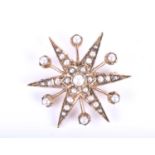 A late 19th / early 20th century yellow gold and pearl brooch, of star-shaped design, the arms set