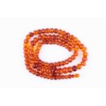 A graduated opera length faceted amber bead necklace, largest bead approx 22mm wide, smallest approx