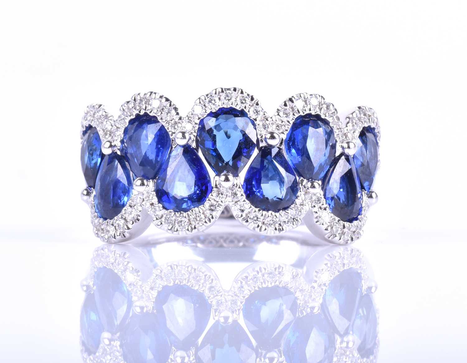 An 18ct white gold, diamond and sapphire ring, the rounded mount set with a row of mixed pear-cut - Image 5 of 8