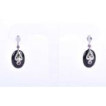 A pair of diamond, black onyx and gemstone drop earrings, each with a line of diamonds, set with a