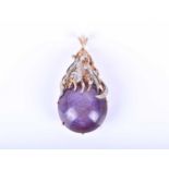 A 14ct yellow gold, diamond and star sapphire pendant, set with a large round cabochon corundum of