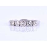 A five stone diamond ring, set with round brilliant-cut diamonds of approximately 0.60 carats