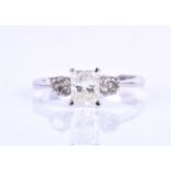 A 14k and diamond ring, cented with a mixed rectangular-cut diamond of approximately 0.60 carats,