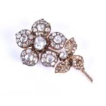A late 19th / early 20th century diamond floral brooch, set with rose-cut diamonds, centred with a
