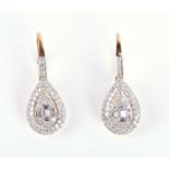 A pair of yellow metal and diamond drop earrings, the tear-drop mounts set with baguette and round
